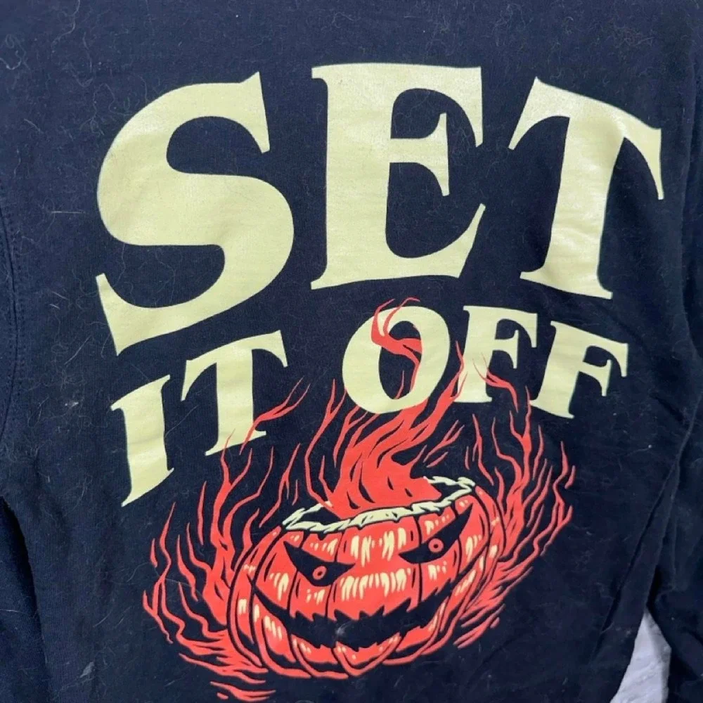 Black crewneck sweatshirt with yellow SET IT OFF flaming jack-o'-lantern size S